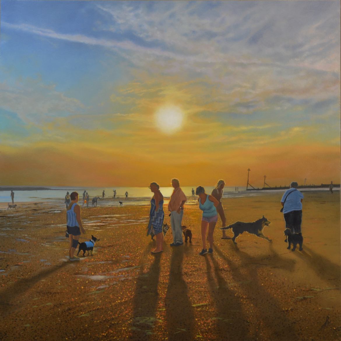 An oil painting by artist Ja Edwards of people, and their dogs, on the beach in the setting sun